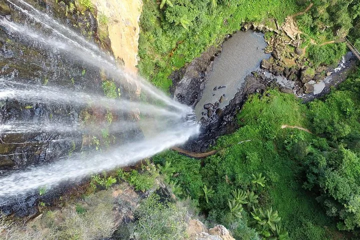 A view looking down at a waterfall and a pool of water.